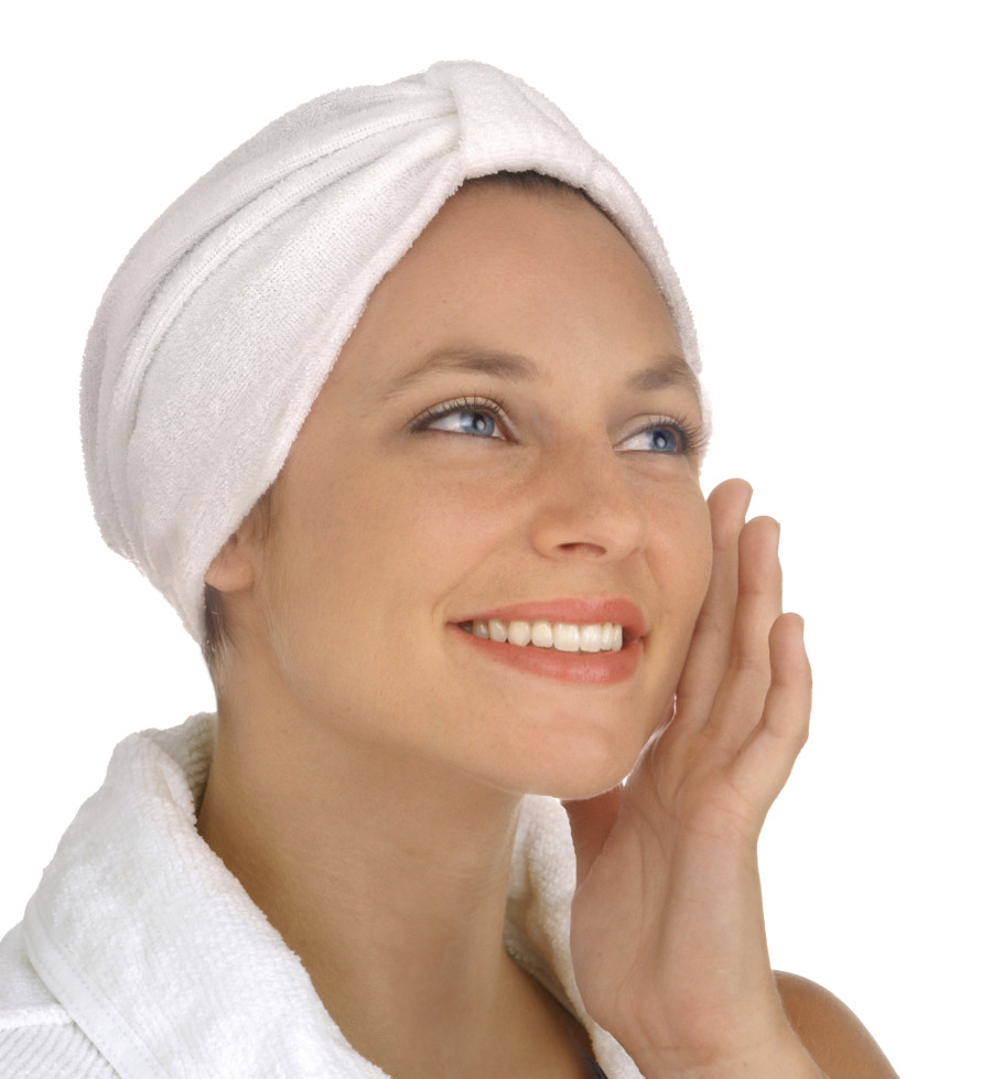 pretty woman holding hand against face wearing spa robe and turban